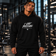 Man wearing the black I EAT PRESSURE microterry pullover hoodie, front lifestyle view