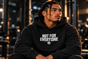 NOT FOR EVERYONE men's black microterry hoodie, seated lifestyle view